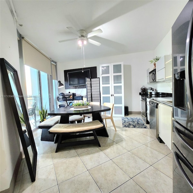 dining space featuring ceiling fan and light tile patterned floors