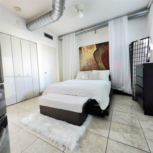 bedroom featuring visible vents, a closet, and light tile patterned flooring