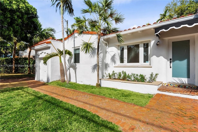 view of home's exterior featuring a lawn and a garage