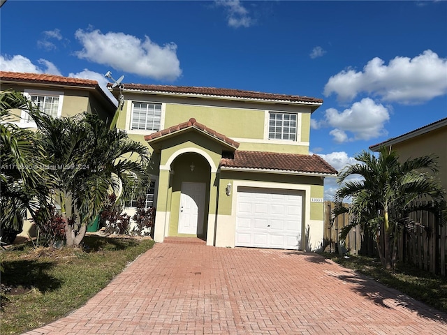 mediterranean / spanish-style house with a garage