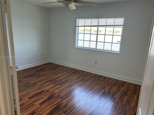 empty room featuring ceiling fan and dark wood-type flooring