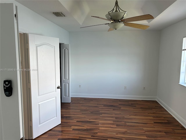 empty room featuring ceiling fan and dark wood-type flooring