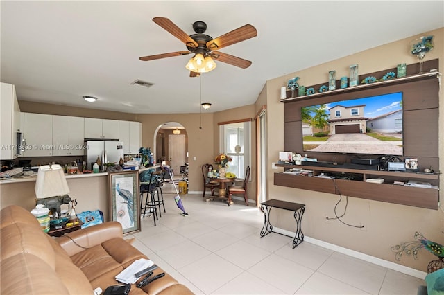 tiled living room with ceiling fan