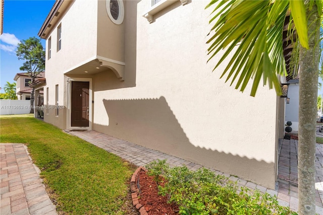 doorway to property with a yard