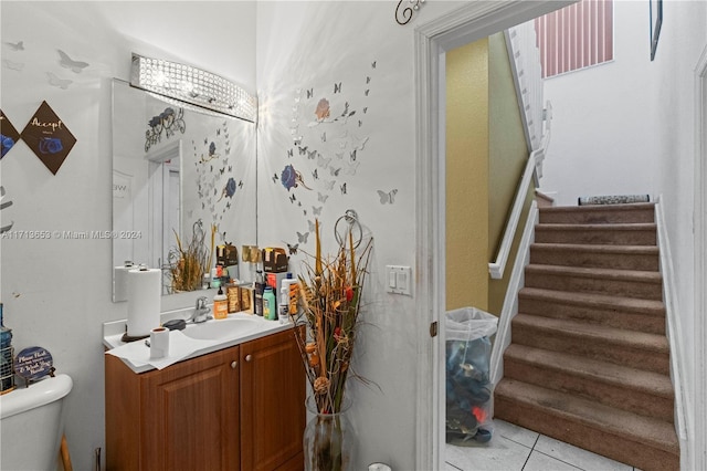 bathroom featuring tile patterned flooring, vanity, and toilet