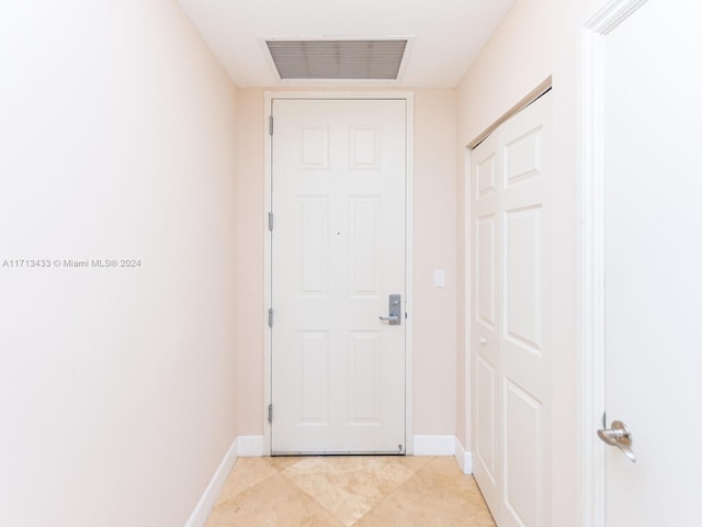 doorway to outside featuring light tile patterned flooring