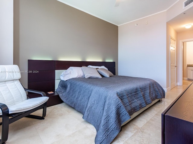 bedroom with ceiling fan and ornamental molding