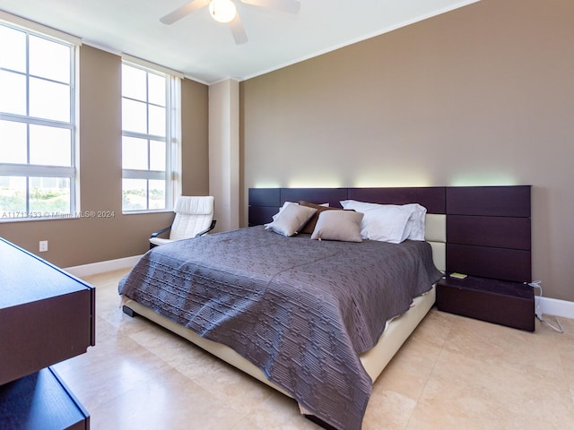 bedroom featuring ceiling fan and crown molding