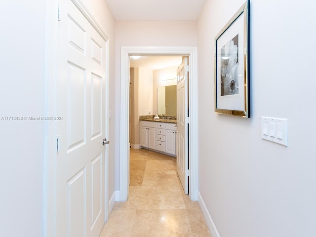 hall featuring light tile patterned flooring