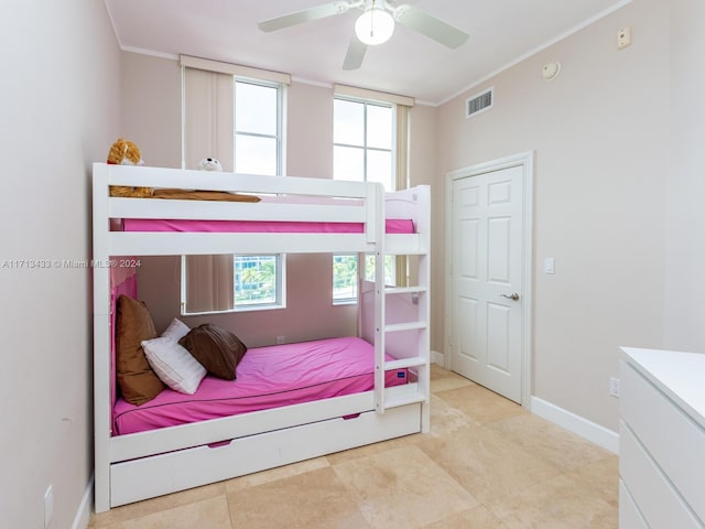 bedroom featuring ceiling fan and ornamental molding