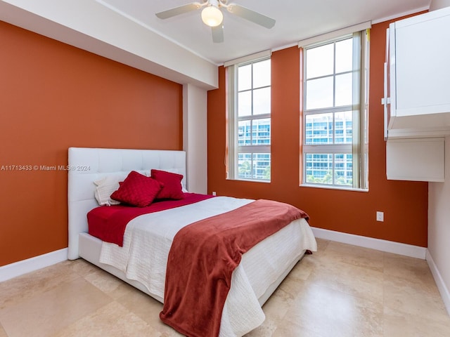 bedroom with multiple windows and ceiling fan