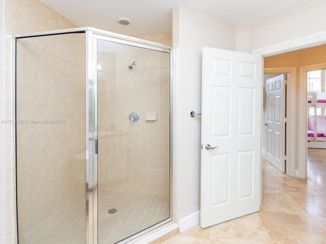 bathroom with tile patterned flooring and an enclosed shower