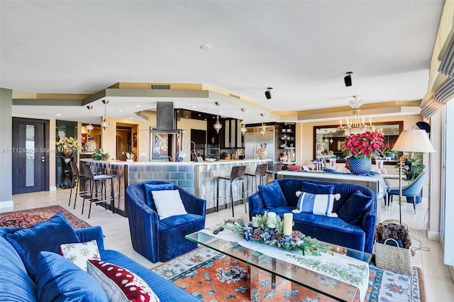 tiled living room featuring an inviting chandelier