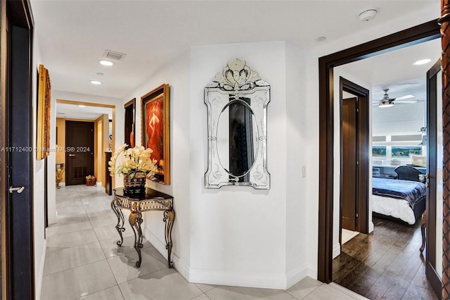 corridor featuring light tile patterned floors