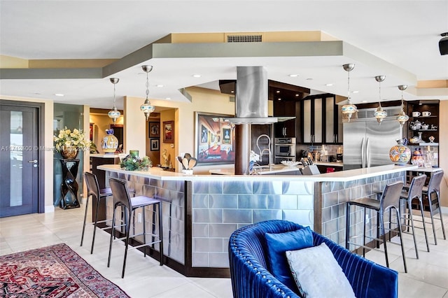 kitchen featuring hanging light fixtures, backsplash, stainless steel appliances, and island exhaust hood