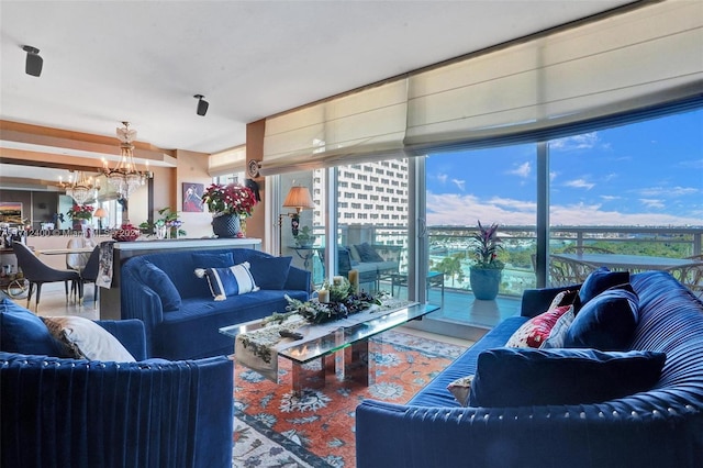 living room featuring a healthy amount of sunlight and a chandelier