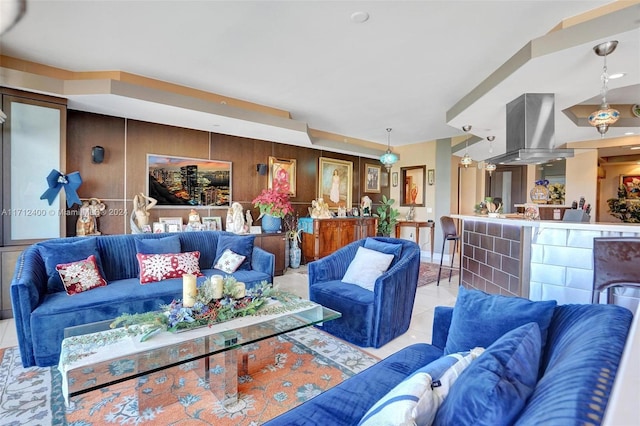 tiled living room featuring wood walls