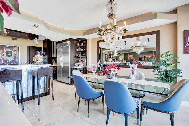 tiled dining space featuring a chandelier