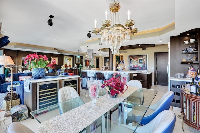 dining room with bar, light tile patterned floors, a raised ceiling, a notable chandelier, and beverage cooler