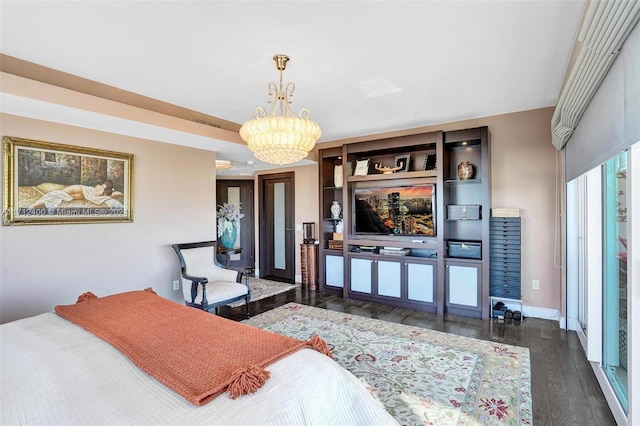 bedroom with dark wood-type flooring and an inviting chandelier