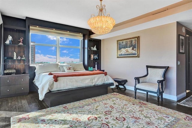 bedroom featuring dark hardwood / wood-style floors and a notable chandelier