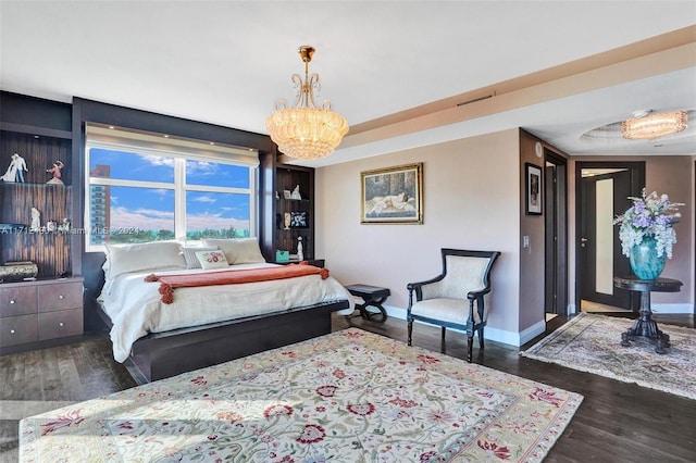 bedroom featuring dark hardwood / wood-style flooring and a notable chandelier