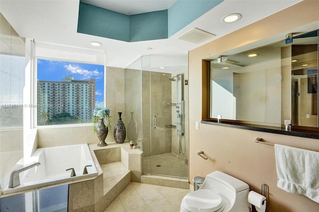 bathroom featuring toilet, tile patterned floors, and shower with separate bathtub