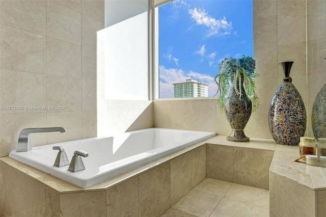 bathroom with tile walls and tiled tub