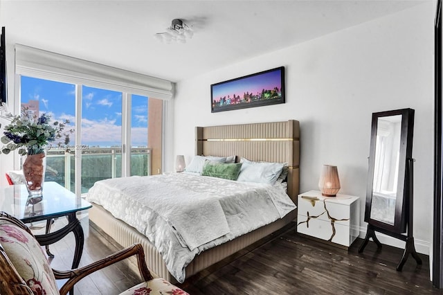 bedroom featuring dark hardwood / wood-style flooring and access to outside