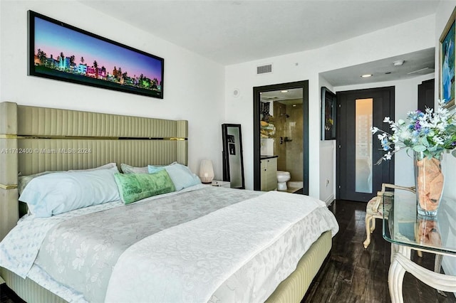 bedroom featuring dark hardwood / wood-style flooring and ensuite bathroom