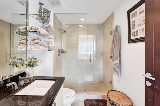 bathroom with vanity, an enclosed shower, and toilet