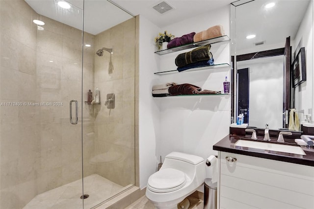 bathroom featuring vanity, an enclosed shower, and toilet