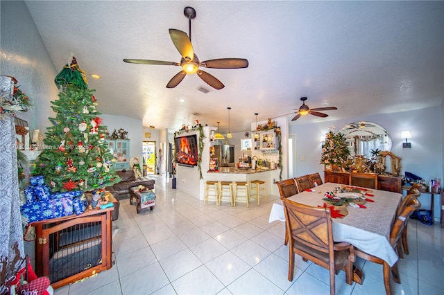 dining room with ceiling fan, visible vents, a textured ceiling, and light tile patterned flooring