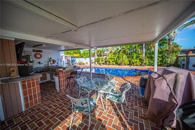 view of patio / terrace with a fenced in pool, area for grilling, a grill, and fence