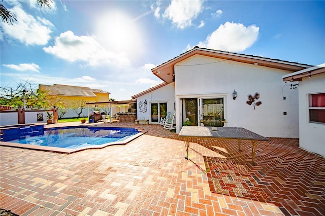 view of swimming pool featuring a patio and a pool with connected hot tub