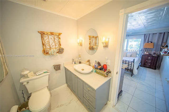 bathroom with toilet, marble finish floor, ornamental molding, baseboards, and vanity