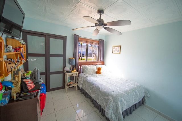 bedroom featuring light tile patterned floors and a ceiling fan