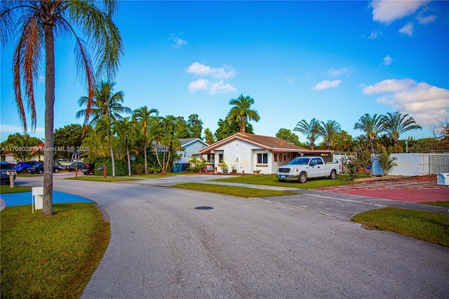 exterior space featuring a front lawn and fence