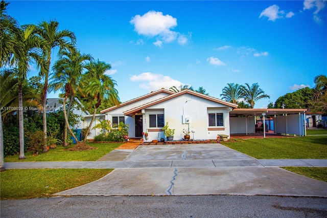 ranch-style house with stucco siding, an attached carport, concrete driveway, and a front lawn