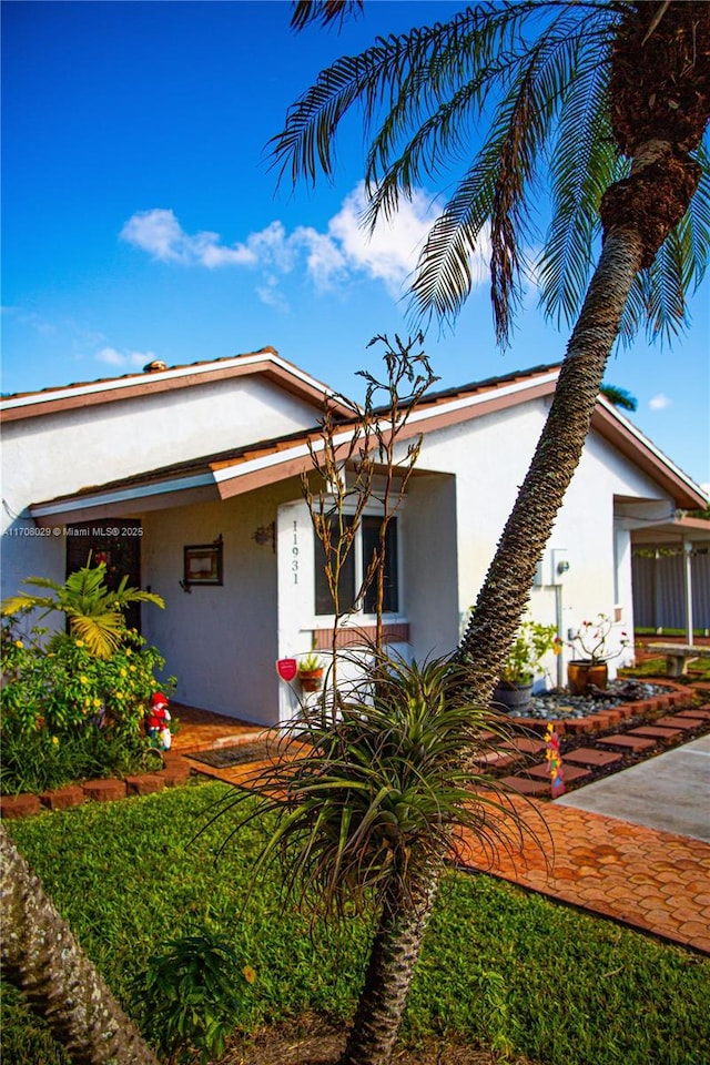 view of front facade with a porch and stucco siding