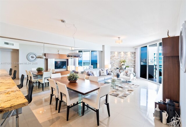 tiled dining area featuring floor to ceiling windows