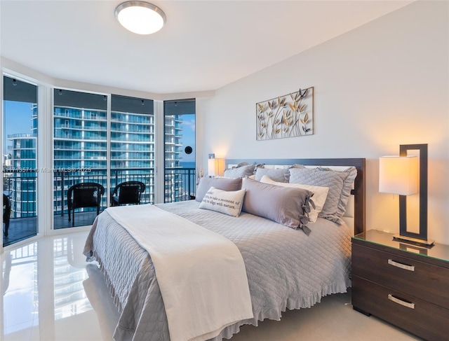 bedroom featuring multiple windows and floor to ceiling windows