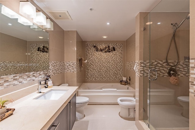 full bathroom featuring toilet, tile patterned floors, shower with separate bathtub, and tile walls