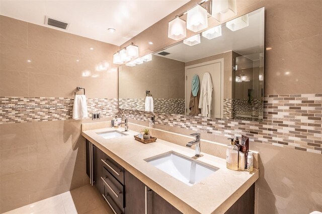 bathroom featuring tile patterned floors, vanity, and tile walls