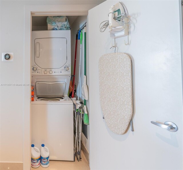 washroom featuring stacked washer / drying machine