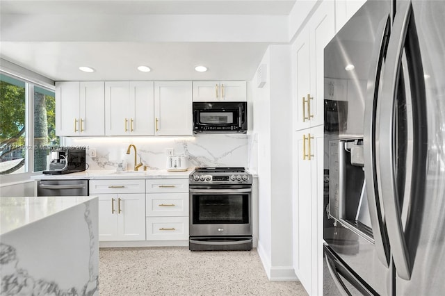 kitchen with white cabinets, decorative backsplash, sink, and stainless steel appliances