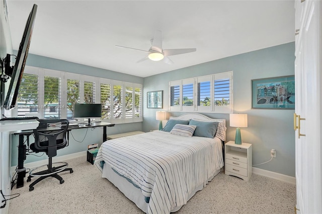 bedroom featuring multiple windows and ceiling fan