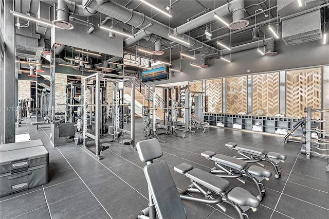 gym featuring a towering ceiling