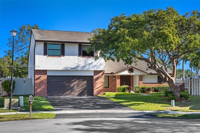 view of front of property with a front lawn and a garage