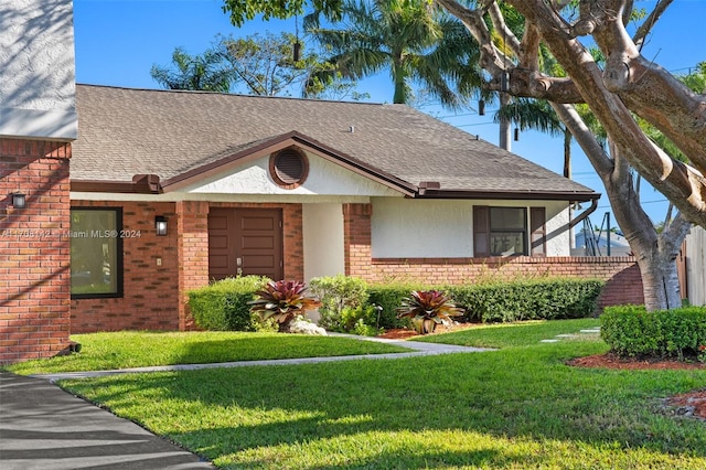 single story home with a front yard